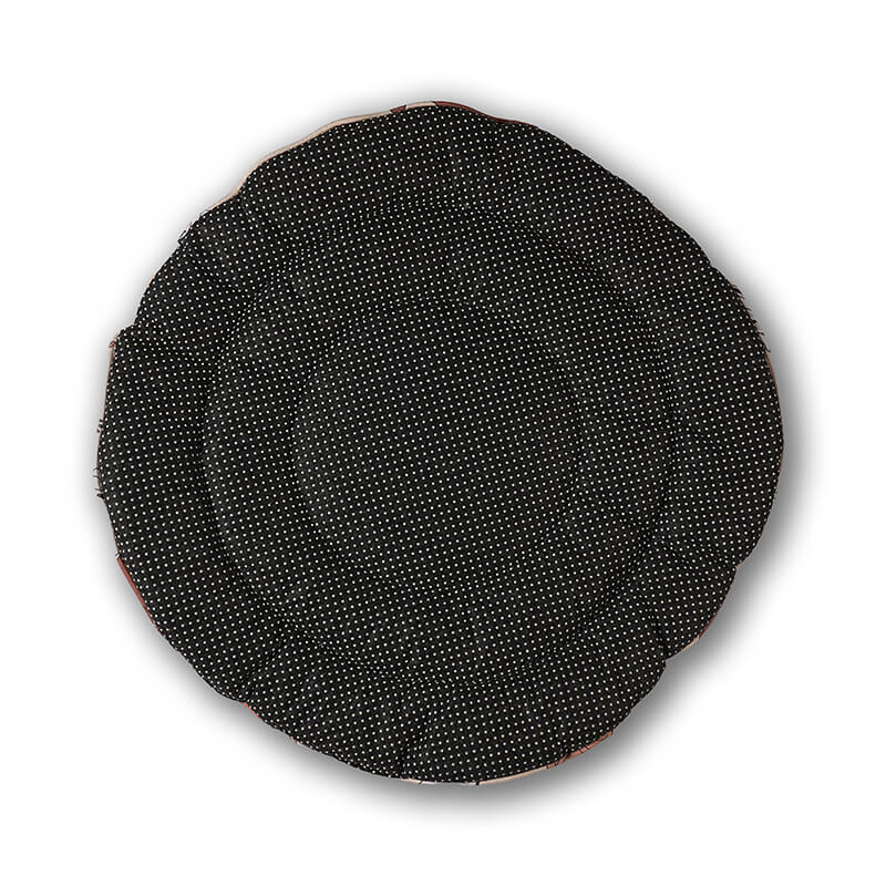 Bottom view of the Dog Daze round pet mat showing a black anti-slip base with white dotted grip texture, designed to keep the mat securely in place on smooth floors.