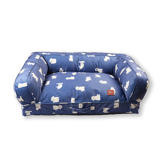 Blue Luxe Lounge Sofa Bed for dogs with raised cushioned sides, soft fabric upholstery featuring white dog prints, front carry handle, and DODO Pet Care logo, isolated on a white background.