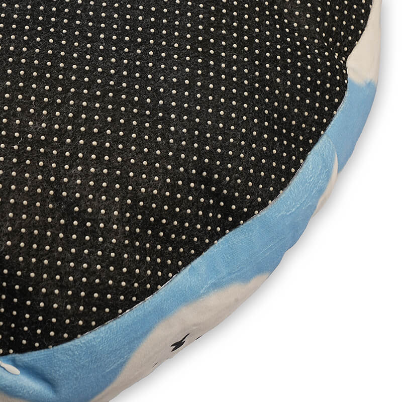 Bottom view of Cloudy Pup Bed showing black dotted anti-slip fabric with soft cloud print side panel for stable pet comfort