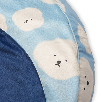 Close-up side view of Cloudy Pup Bed showing soft blue fabric with cute cloud face print and plush cushioning for pet comfort