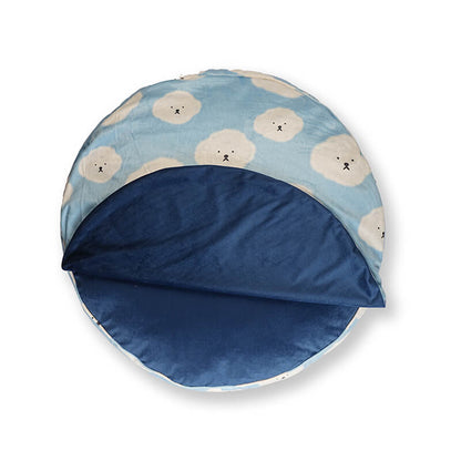 Cloudy Pup Bed round pet bed with reversible design, featuring soft blue velvet interior and playful cloud print exterior for cozy pet comfort