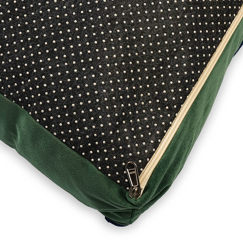 Close-up of Luna Lounge Bed showing zipper detail with reversible design, black dotted anti-slip fabric and green velvet edge