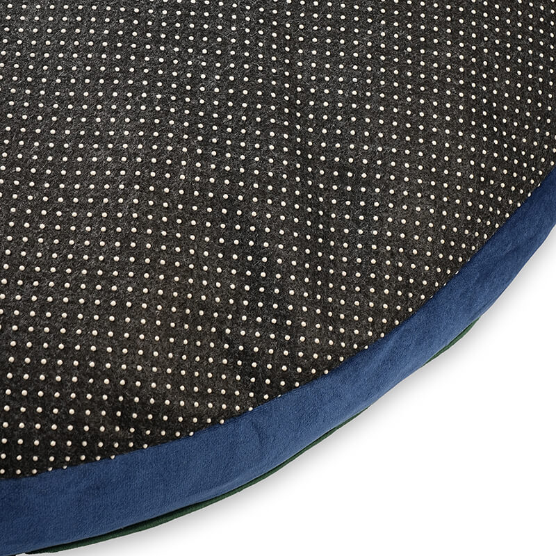 Close-up of Luna Round Bed bottom showing black dotted anti-slip fabric with blue velvet edge for stability