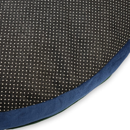 Close-up of Luna Round Bed bottom showing black dotted anti-slip fabric with blue velvet edge for stability