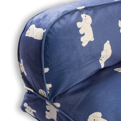 Close-up view of the Luxe Lounge Sofa Bed highlighting the raised cushioned side and backrest, featuring soft blue velvety fabric with white dog prints, smooth piping, and plush supportive padding on a white background.