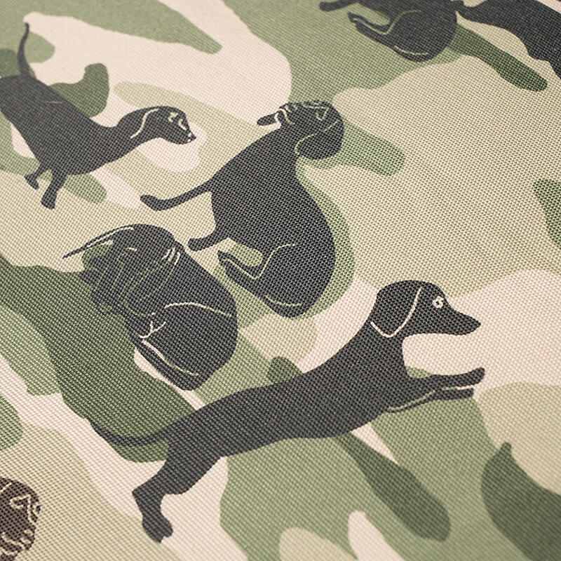 Close-up of Military Bed camouflage fabric featuring dog silhouette print on durable textured material