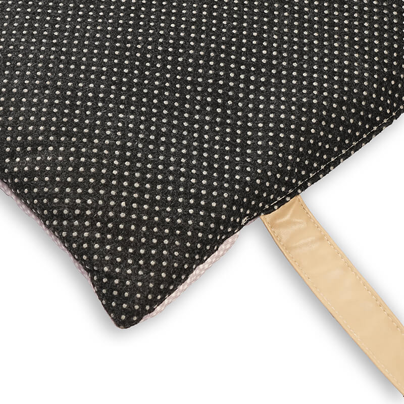 Close-up of Sniffy travel mat underside featuring dotted anti-slip fabric and sturdy carry strap, designed to keep the pet mat securely in place during use
