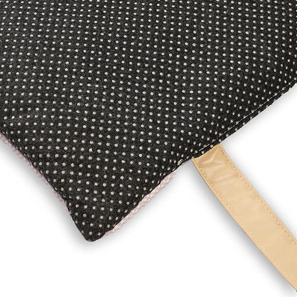 Close-up of Sniffy travel mat underside featuring dotted anti-slip fabric and sturdy carry strap, designed to keep the pet mat securely in place during use