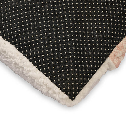 Close-up of the Teddy Snug Bed’s black anti-slip dotted base with soft white fleece edging, designed to prevent sliding and add cozy comfort for pets.