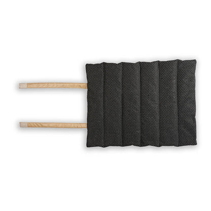 Black dotted non-slip bottom of Treatos travel mat for pets, featuring padded quilting and long straps for secure folding and easy portability.