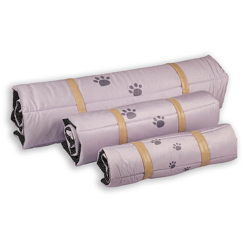 Three Treatos travel mats in different sizes shown rolled up with beige securing straps, featuring a soft lavender surface with paw print design and compact, portable form for pets.