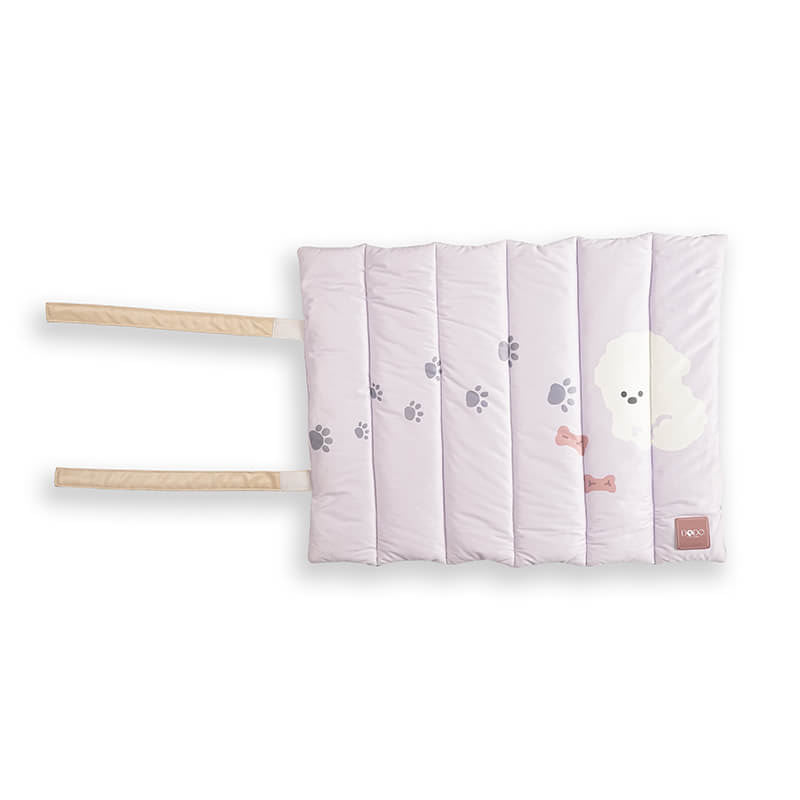 Soft padded Treatos travel mat for pets in a light pastel color with paw print design, featuring foldable straps for easy carrying and comfortable on-the-go use.