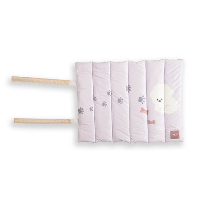 Soft padded Treatos travel mat for pets in a light pastel color with paw print design, featuring foldable straps for easy carrying and comfortable on-the-go use.