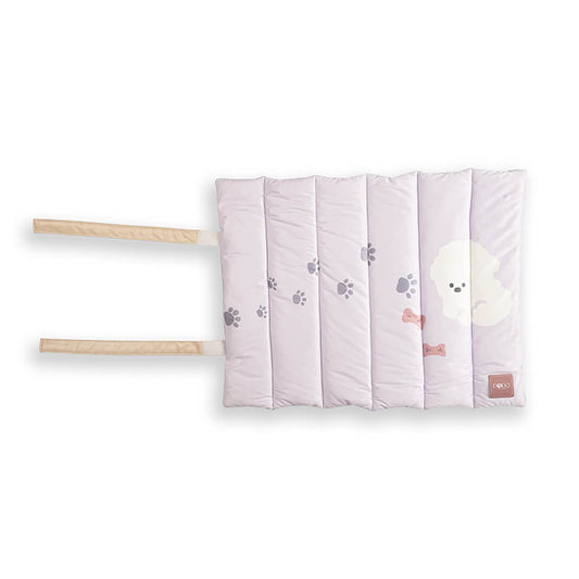 Soft padded Treatos travel mat for pets in a light pastel color with paw print design, featuring foldable straps for easy carrying and comfortable on-the-go use.